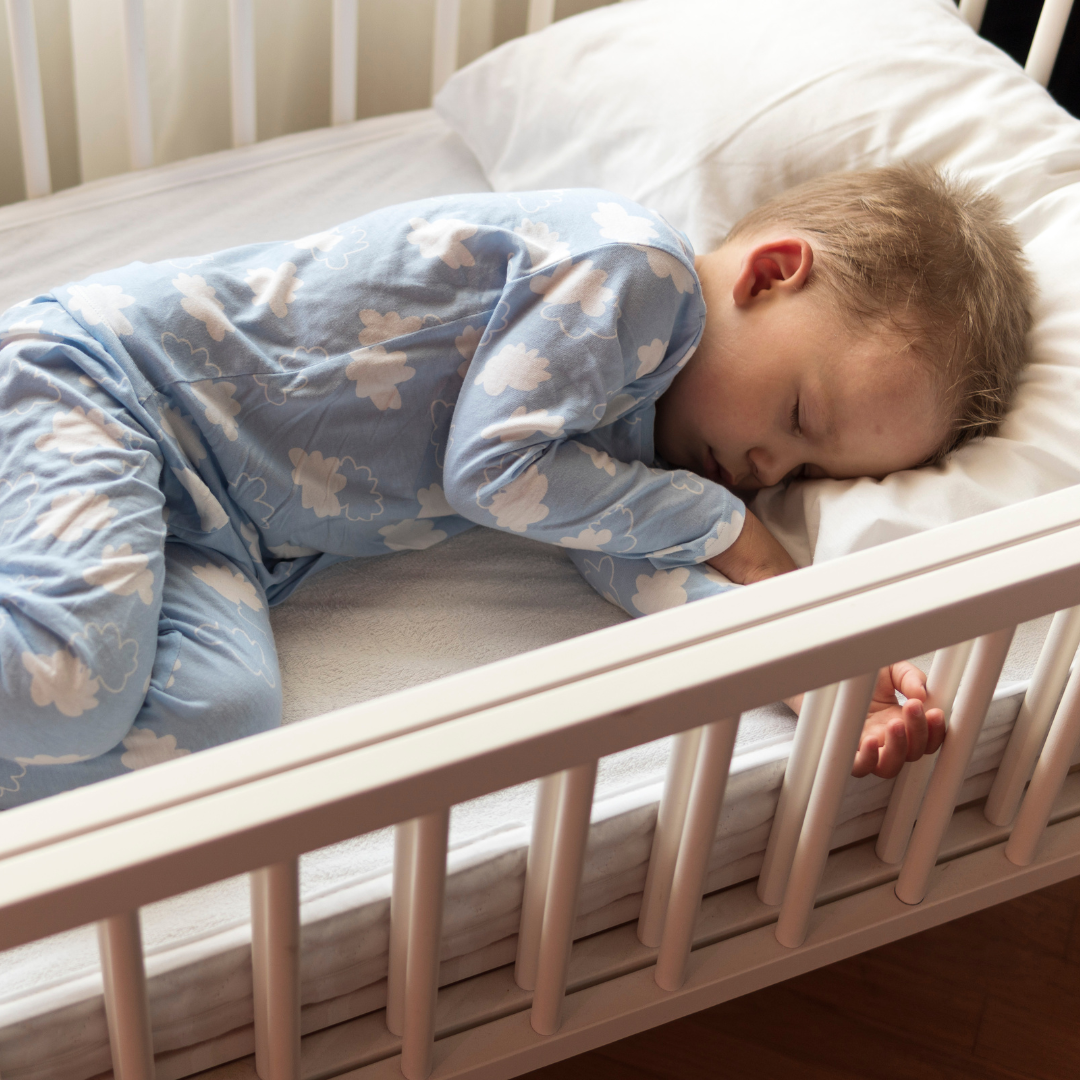 toddler sleeping in crib